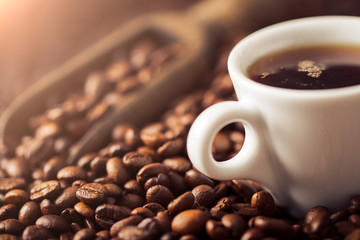 Ground coffee and coffee beans on old cafe table.