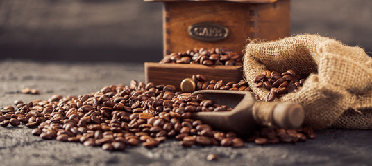 Ground coffee and coffee beans on old cafe table.