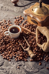 Ground coffee and coffee beans on old cafe table.