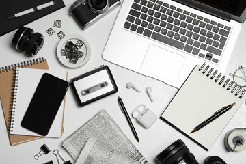 Flat lay composition with equipment for journalist on white table