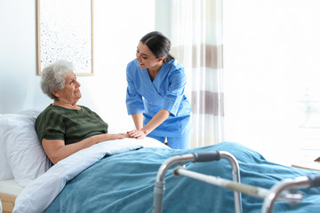 Care worker with elderly woman in geriatric hospice