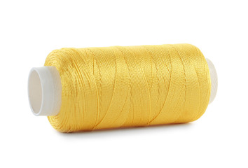 Spool of yellow sewing thread isolated on white
