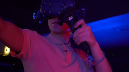 Man using virtual reality headset and controllers. Gaming in virtual relaity. High-tech advancements in video game industry. 