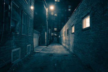 Naklejka na ściany i meble Dark and eerie urban city alley at night 