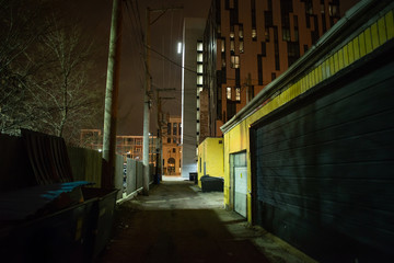 Dark and eerie urban city alley at night 