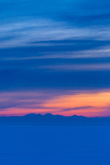 Dreamy blue and pink snowy landscape at sunrise or sunset