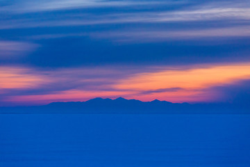 Dreamy blue and pink snowy landscape at sunrise or sunset