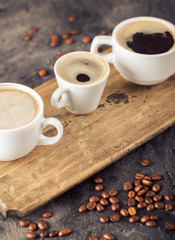 Ground coffee and coffee beans on old cafe table. Different various of coffee