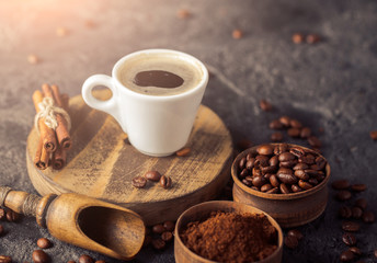 Ground coffee and coffee beans on old cafe table.