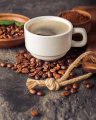 Ground coffee and coffee beans on old cafe table.