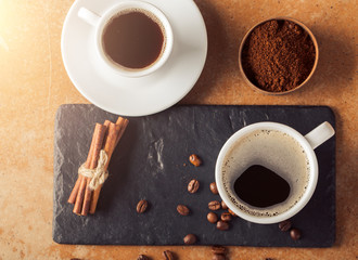 Ground coffee and coffee beans on old cafe table.
