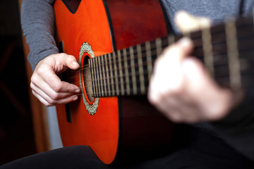 girl playing an acoustic guitar. string musical instrument guitar