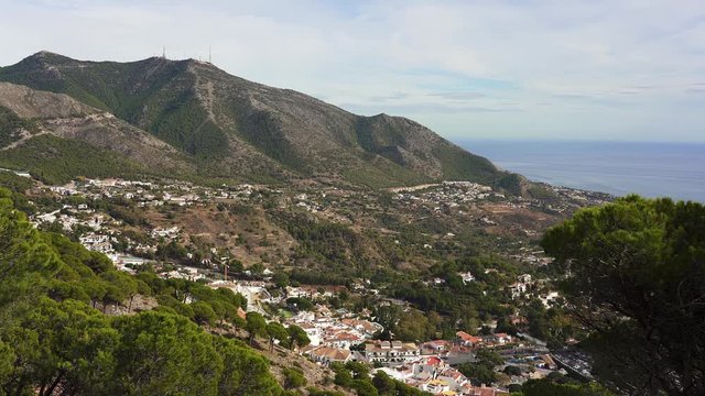 View over the old white town of Mijas and the Costa del Sol and Mediterranean Sea coast. Spain