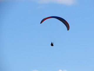 Paraglide flight in blue sky