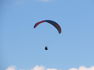 Paraglide flight in blue sky