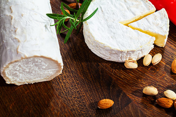 Camembert cheese or brie on wooden background