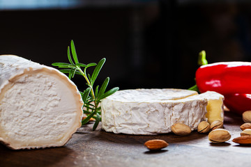 Camembert cheese or brie on wooden background