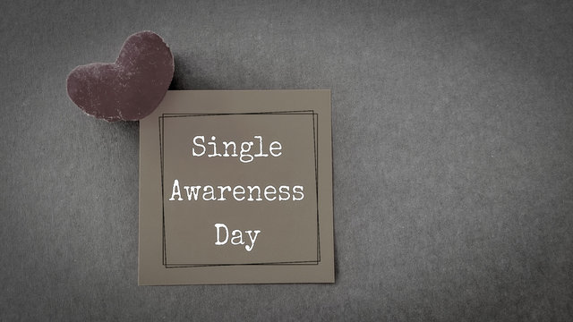 inspirational words of single awareness day written on notepaper in vintage background