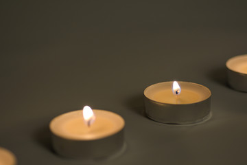 Obraz na płótnie Canvas Small romantic candles against a dark background