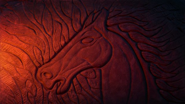 Horse Depiction Rock Carving In Fire Glow