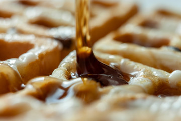 Homemade waffle with syrup and butter.