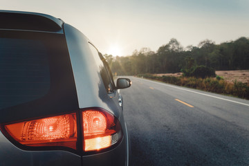 Vintage tone of luxury family car open light signal on the asphalt.  Traveling to travel on mountainous areas and forests.