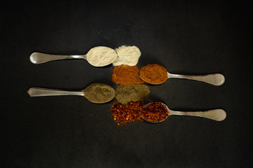 spilled spices on a black background