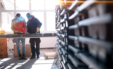 team of mining  workers measuring drilled rock core