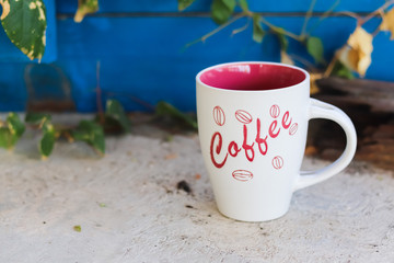 Red and White coffee mug on the ground