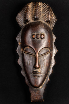 African mask souvenir isolated on a black background. Gift concept.