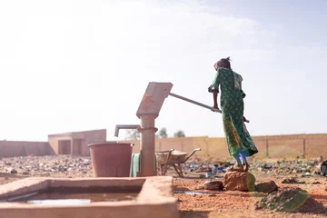 Foto op Aluminium Joyful Native African Young Woman Carrying Healthy Water in a village © Riccardo Niels Mayer