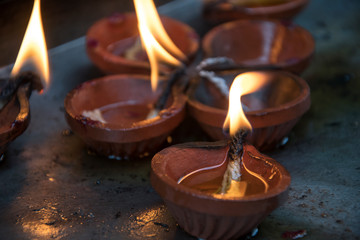 Burning lit diya clay oil lamps