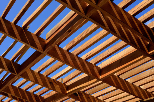 wooden pergola in the sun with blue sky