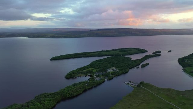 Lusty Beg Island during colorful sunset in Northern Ireland, high backwards aerial