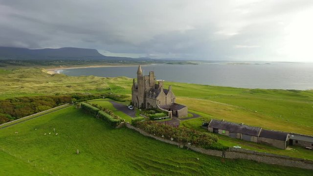 Classiebawn Castle in scenic rural landscape in Ireland, backwards aerial