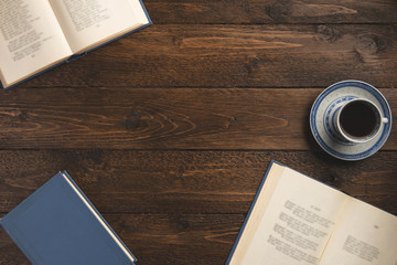 Books  and  cup of coffee, isolated on wooden background. Flat lay, top view, copy space.