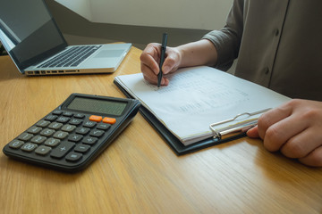 Bank employees sit and work and check the financial summary..Working in an office, a consultancy and a summary.