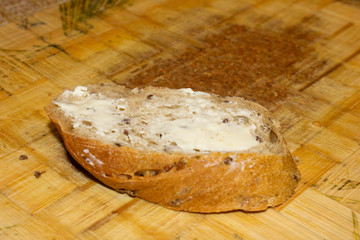 Bread with cereals and butter on a board