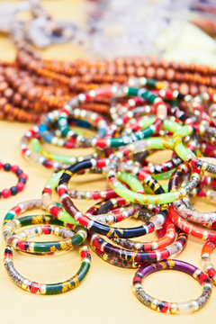 Close-up view of colorful wooden rosary bracelets and arm rings filled with spiritual content for sale by indigenous aeta vendors in the Philippines