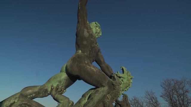 Beautiful Statue of a Hungarian warrior fighting a three-headed dragon on top of Gellert Hill, Budapest, Hungary During Sunny Day - Tilt Up Shot