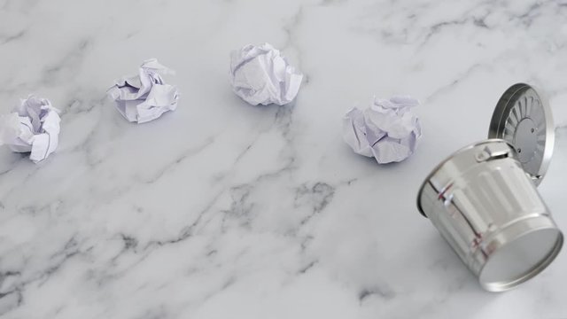 creative block or burnout, group of scrunched paper ball drafts going into garbage bin and hand swapping one for a notepad