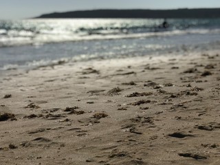 Sandy beach Tarifa Andalucia Spain. Beautiful clean and fine sand on the Atlantic coast in Europe. A favorite place for both locals and tourists, footprints and shoes in the sand on the beach