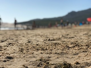 Sandy beach Tarifa Andalucia Spain. Beautiful clean and fine sand on the Atlantic coast in Europe. A favorite place for both locals and tourists, footprints and shoes in the sand on the beach