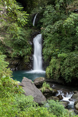 Fototapeta na wymiar Beautiful view of the waterfall with smooth water falling among the rocks in Taiwan