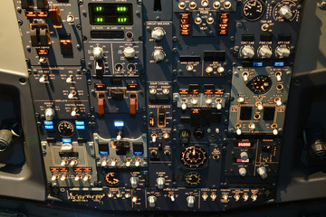 Instruments, switches, of overhead panel  in the cockpit of a 737 commercial airplane.