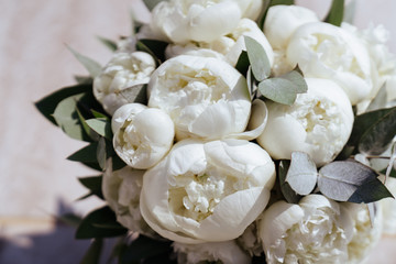 Close-up image of a beautiful and stylish wedding bouquet of white and pink peonies. Summer floral composition.