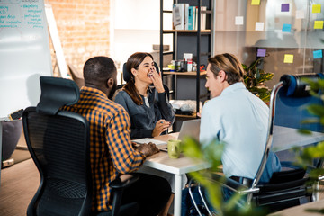 Cheerful female person laughing at funny story
