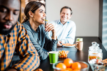 Positive delighted young woman eating healthy food