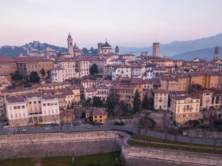 Bergamo, Italy. Drone aerial view of the old town during sunrise. Landscape at the city center, its historical buildings and the Venetian walls a Unesco world heritage