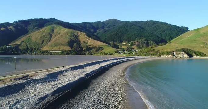 4k slow forward tracking aerial view of the natural boulder barrier causeway beside the sea connecting Pepin island with south island at the area known as Cable Bay,Rotokura,South Island New Zealand